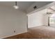 Bright living room with plush brown carpet, large window, and ceiling fan at 700 E Mesquite Cir # O210, Tempe, AZ 85288