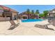 A community pool has lounge chairs and is surrounded by townhomes at 700 E Mesquite Cir # O210, Tempe, AZ 85288