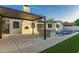 A sprawling backyard with a pool, outdoor kitchen, and covered patio at 720 E Chilton Dr, Tempe, AZ 85283