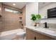 Stylish bathroom featuring a tiled shower with shelves, modern vanity, and decorative plant at 720 E Chilton Dr, Tempe, AZ 85283