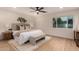 Inviting bedroom with light, soft colors, a ceiling fan, and large window letting in natural light at 720 E Chilton Dr, Tempe, AZ 85283