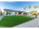 Beautiful single-story home with lush lawn, mature palm trees, and modern fence at 720 E Chilton Dr, Tempe, AZ 85283