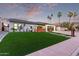 Beautiful single-story home with lush lawn, mature palm trees, and modern fence at 720 E Chilton Dr, Tempe, AZ 85283