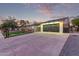 Single-story house with a large driveway and garage, enhanced by modern architectural details at 720 E Chilton Dr, Tempe, AZ 85283