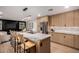 Modern kitchen features a large marble island, stainless steel appliances, and custom wood cabinetry at 720 E Chilton Dr, Tempe, AZ 85283
