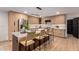 Stylish kitchen with an island, modern light wood cabinets, stainless steel appliances, and barstool seating at 720 E Chilton Dr, Tempe, AZ 85283