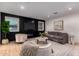 Comfortable living room showcasing a black accent wall with a modern fireplace and a large TV at 720 E Chilton Dr, Tempe, AZ 85283