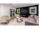 Cozy living room features a black accent wall, modern furniture, and sliding glass doors to the backyard at 720 E Chilton Dr, Tempe, AZ 85283