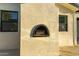 An exterior shot of an outdoor fireplace detail adds charm to the property at 720 E Chilton Dr, Tempe, AZ 85283