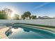 Swimming pool with attached spa surrounded by a white block privacy wall and artifical turf at 720 E Chilton Dr, Tempe, AZ 85283