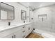 Renovated bathroom features dual vanity, quartz countertop, and glass enclosed shower at 724 W Missouri Ave, Phoenix, AZ 85013