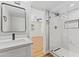 Renovated bathroom features a glass-enclosed shower and vanity with quartz countertop at 724 W Missouri Ave, Phoenix, AZ 85013