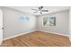A bright bedroom features neutral walls and wood laminate floors at 724 W Missouri Ave, Phoenix, AZ 85013