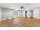 This bedroom has wood floors, a ceiling fan, and sliding-door closets, and a view of the backyard pool at 724 W Missouri Ave, Phoenix, AZ 85013