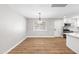 The kitchen features white cabinets, quartz countertops, hard surface flooring and stainless steel appliances at 724 W Missouri Ave, Phoenix, AZ 85013