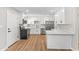 This modern kitchen has white cabinets, hard surface floors, quartz countertops and stainless steel appliances at 724 W Missouri Ave, Phoenix, AZ 85013