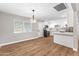 The kitchen features white cabinets, quartz countertops, hard surface flooring and stainless steel appliances at 724 W Missouri Ave, Phoenix, AZ 85013