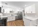 The kitchen features white cabinets, quartz countertops, hard surface flooring and stainless steel appliances at 724 W Missouri Ave, Phoenix, AZ 85013