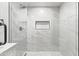 This remodeled walk-in shower features elegant marble-like tiling and matte black fixtures at 724 W Missouri Ave, Phoenix, AZ 85013