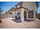 The home's backyard features a covered patio and low-maintenance desert landscaping, ideal for relaxation and entertaining at 7712 S 64Th Ln, Laveen, AZ 85339