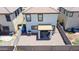 Aerial view of a private backyard with stone landscaping and a covered patio area with grill and seating at 7712 S 64Th Ln, Laveen, AZ 85339