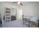 Bedroom featuring neutral walls, carpet, storage shelves and a desk with a white accent chair at 7712 S 64Th Ln, Laveen, AZ 85339