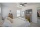 Bright bedroom featuring neutral walls, carpet, ceiling fan, dresser, and a comfortable queen size bed at 7712 S 64Th Ln, Laveen, AZ 85339