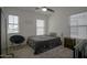 Bright bedroom with a cozy sitting area, plush carpet, and large windows providing natural light at 7712 S 64Th Ln, Laveen, AZ 85339