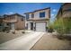 Charming two-story home with a well-maintained front yard and a convenient two-car garage at 7712 S 64Th Ln, Laveen, AZ 85339
