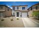 Attractive two-story home featuring tidy landscaping and a practical two-car garage at 7712 S 64Th Ln, Laveen, AZ 85339