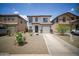 Welcoming two-story home with desert landscaping and a convenient two-car garage in a quiet neighborhood at 7712 S 64Th Ln, Laveen, AZ 85339