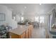 Bright open concept kitchen includes stainless appliances, island with bar seating, and flows into dining and living area at 7712 S 64Th Ln, Laveen, AZ 85339