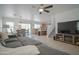 Open concept living room with stairs, dining area, kitchen with tile floors and stainless steel dishwasher at 7712 S 64Th Ln, Laveen, AZ 85339