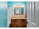 Bright blue bathroom featuring tiled walls, recessed lighting, and wood vanity at 8116 N 55Th Dr, Glendale, AZ 85302