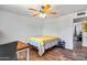 Cozy bedroom with wood floors, desk, ceiling fan, and ample natural light at 8116 N 55Th Dr, Glendale, AZ 85302