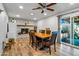 Dining room with modern table, six chairs, decorative fireplace, and outdoor access at 8116 N 55Th Dr, Glendale, AZ 85302