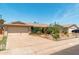Single-Gathering home featuring desert landscaping, a two-car garage, and mature desert trees at 8116 N 55Th Dr, Glendale, AZ 85302