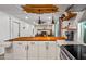 Bright kitchen with butcher block island, custom ceiling accent, and stainless steel appliances at 8116 N 55Th Dr, Glendale, AZ 85302