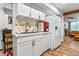 Bright kitchen features white cabinets, stainless sink, and modern appliances at 8116 N 55Th Dr, Glendale, AZ 85302