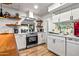 Bright, modern kitchen features wood accents, stainless appliances, and white cabinetry at 8116 N 55Th Dr, Glendale, AZ 85302