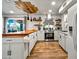 Bright, modern kitchen features custom wood ceiling detail, stainless appliances, and butcher block island at 8116 N 55Th Dr, Glendale, AZ 85302