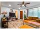 This open living room features wood floors, a ceiling fan, and neutral walls at 8116 N 55Th Dr, Glendale, AZ 85302