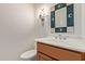 Stylish powder room with a decorative mirror, vanity, and modern fixtures at 8689 E Krail St, Scottsdale, AZ 85250