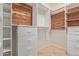 Spacious walk-in closet with custom built-in shelving, drawers, and cedar accents at 8689 E Krail St, Scottsdale, AZ 85250