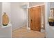 Inviting entryway with light tile flooring, paneled wood door and art niches at 8689 E Krail St, Scottsdale, AZ 85250