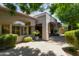 Charming home exterior with lush landscaping, a covered patio, and a paver walkway, exuding curb appeal at 8689 E Krail St, Scottsdale, AZ 85250
