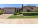 Charming single-story home with stucco exterior, desert landscaping and a paver driveway at 8689 E Krail St, Scottsdale, AZ 85250