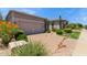 Charming single-story home with stucco exterior, desert landscaping and a paver driveway at 8689 E Krail St, Scottsdale, AZ 85250