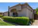 View of the front exterior of the home showcasing the desert landscaping and a paver driveway at 8689 E Krail St, Scottsdale, AZ 85250