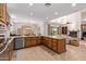 Open kitchen layout with an island, granite counters, and views of the dining and living areas at 8689 E Krail St, Scottsdale, AZ 85250